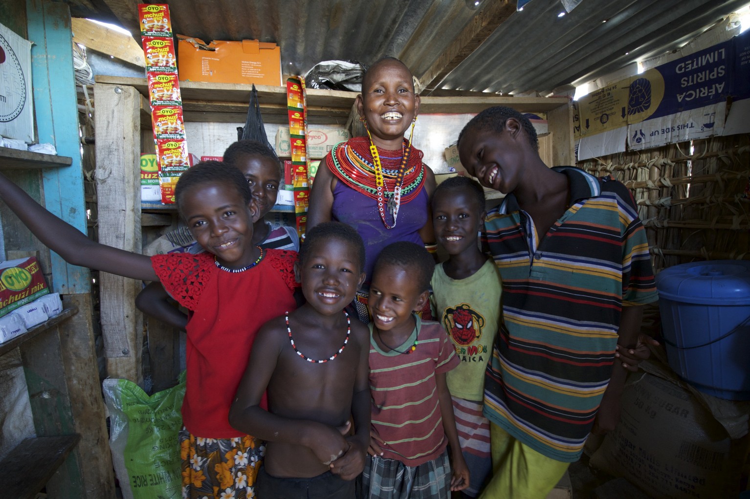 Choro Lemuson pictured with 6 of her 7 children in her shop in El-Molo
